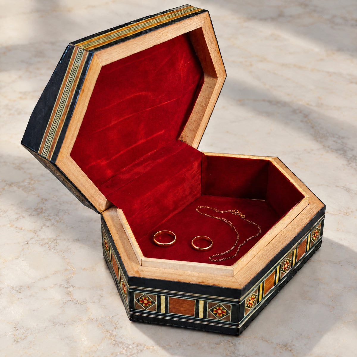 Harmony Mosaic Box open on marble, velvet-lined interior with two rings and a chain