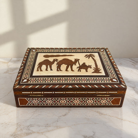 Silk Road Jewelry Box on a white marble table in warm window light