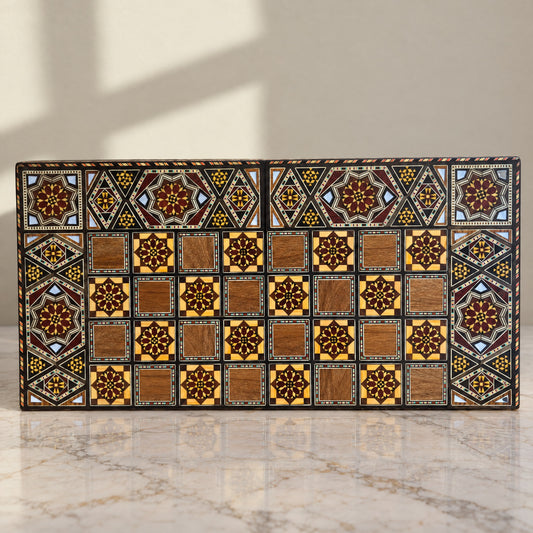 Grandmaster's Chess & Backgammon Set on a white marble table in warm window light
