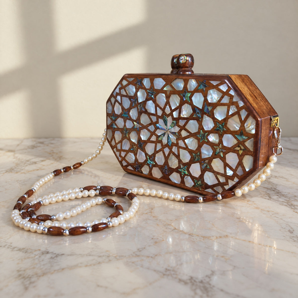 Najmeh Walnut Clutch, closed, on marble
