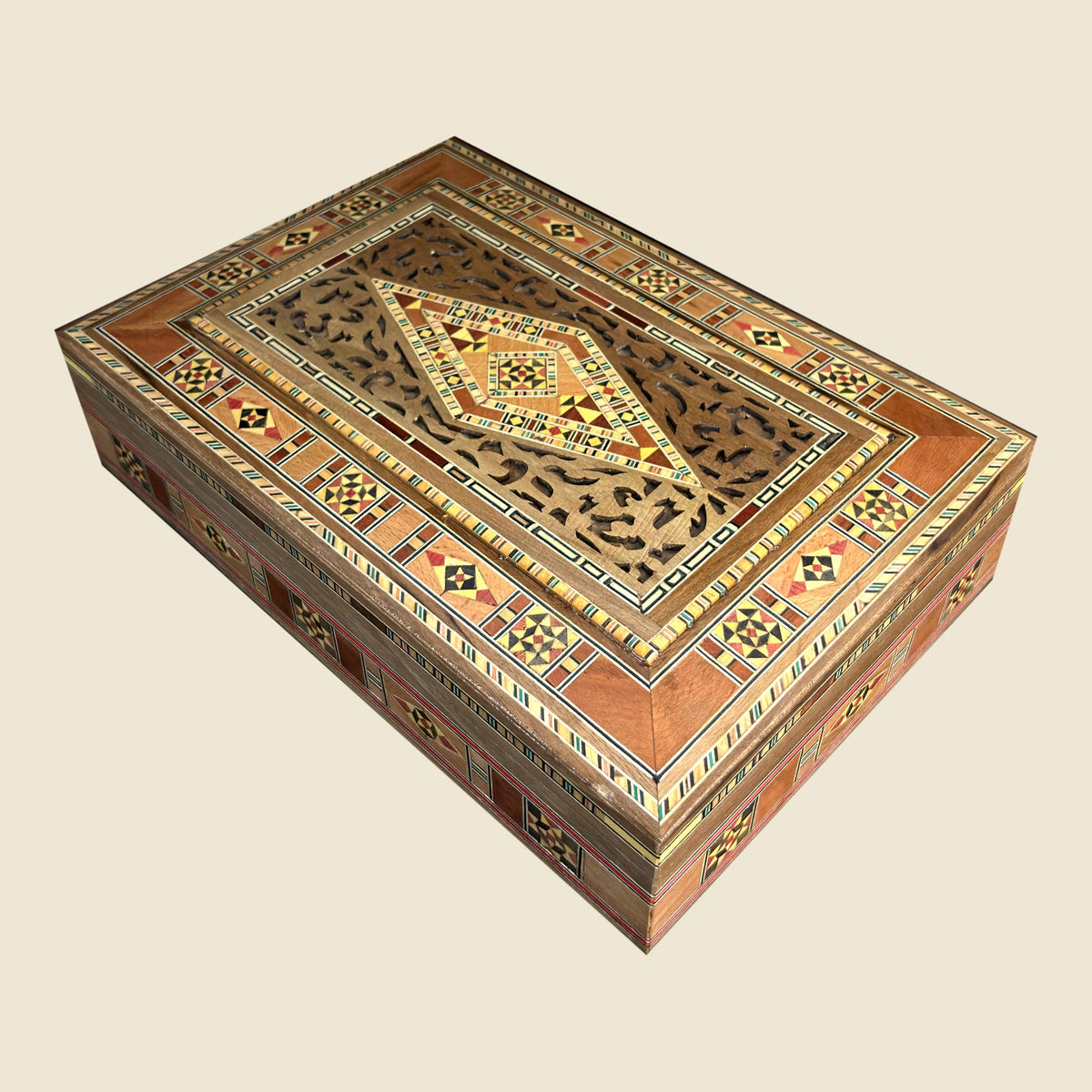 Stately Mosaic Box, closed, with a pierced lid and a geometric mosaic pattern