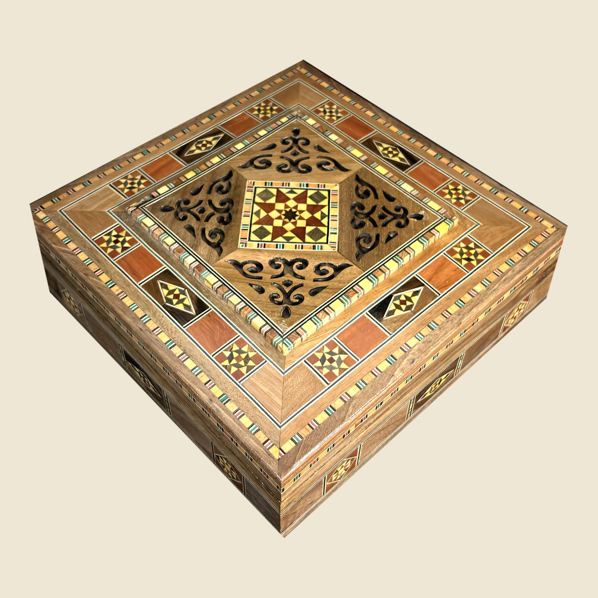 Graceful Mosaic Box, closed, with a pierced lid and a geometric mosaic pattern