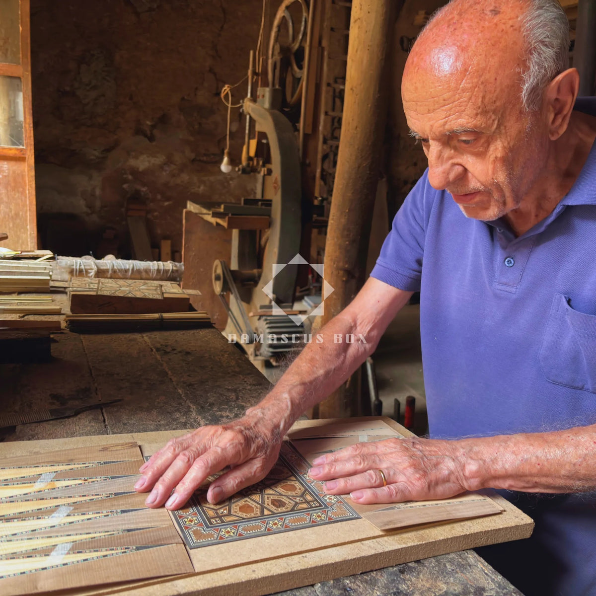 Gabriel Al-Dayeh laying a mosaic backgammon board in his workshop in Damascus