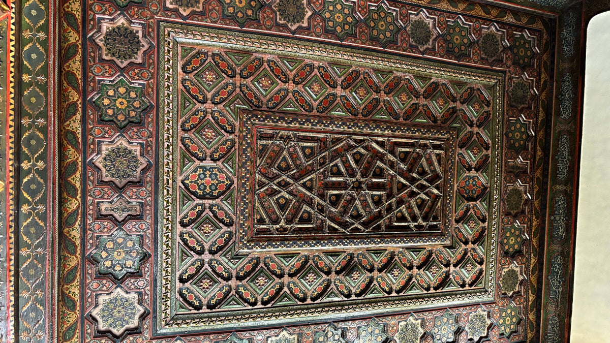 A carved and painted wooden ceiling with star patterns in Azm Palace, Damascus