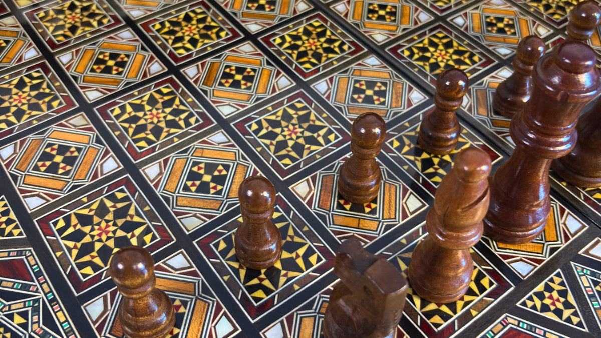 Close-up of the inlaid board of a Damascene chess and backgammon set with wooden chess pieces