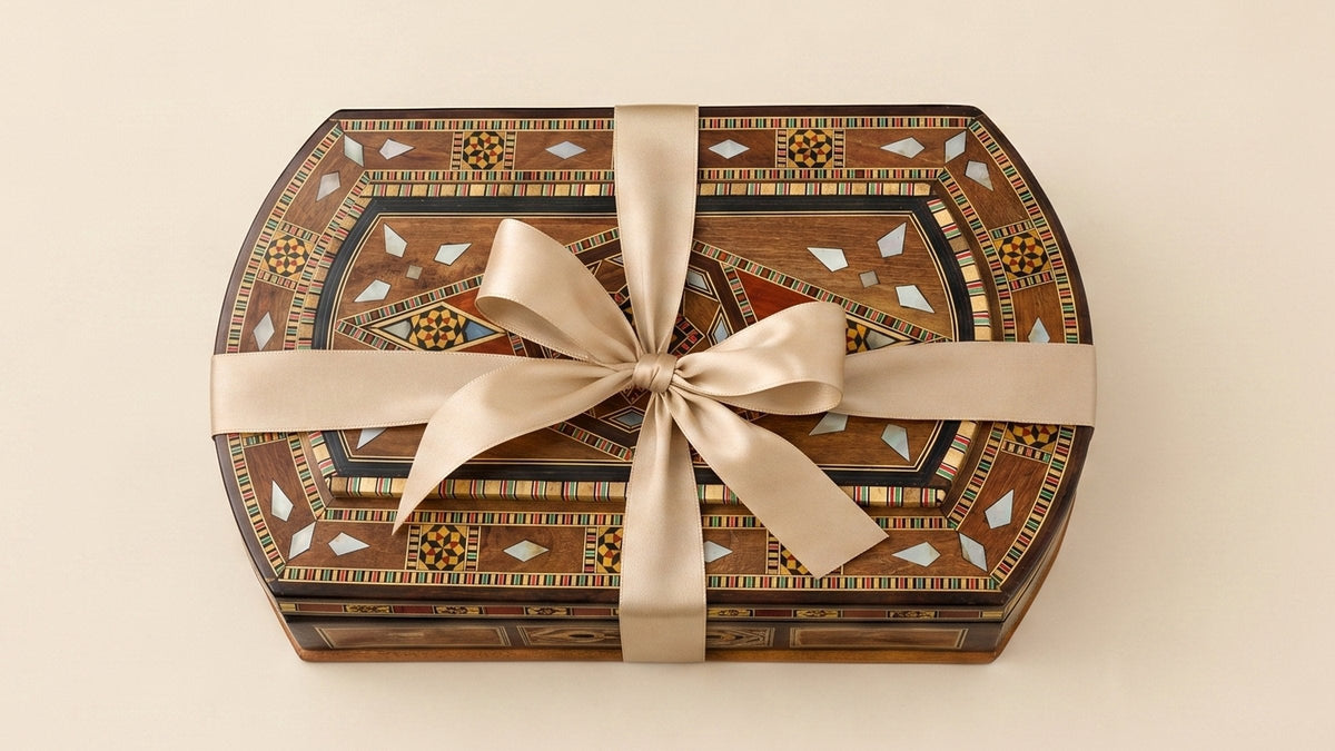 Damascene mosaic box tied with a beige ribbon on a cream background
