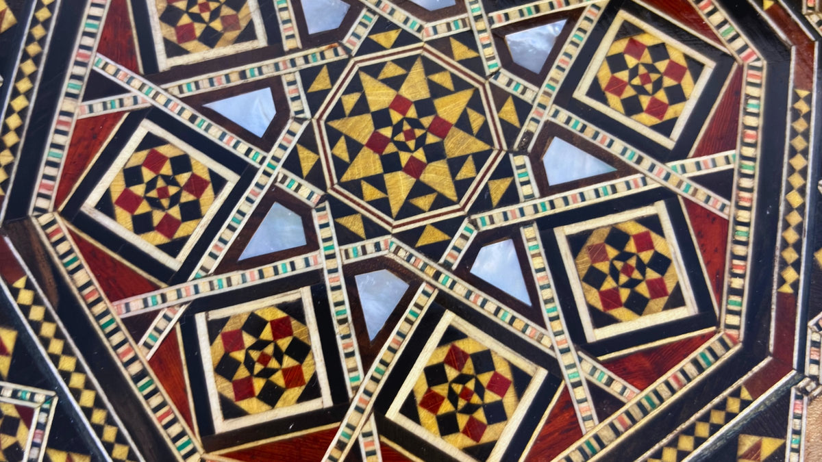 Close-up of a Damascene mosaic octagon pattern in dark wood, light wood and mother-of-pearl