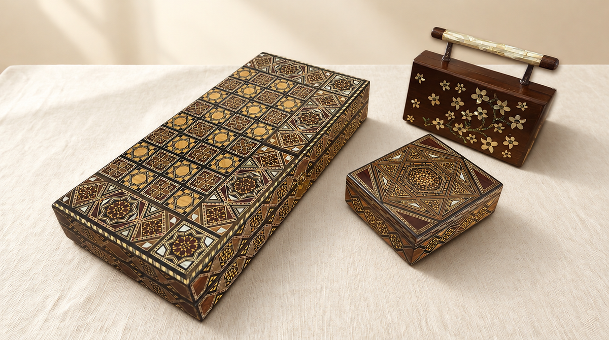 Damascene chess and backgammon set, mosaic box and walnut clutch with mother-of-pearl flowers on a cream linen table