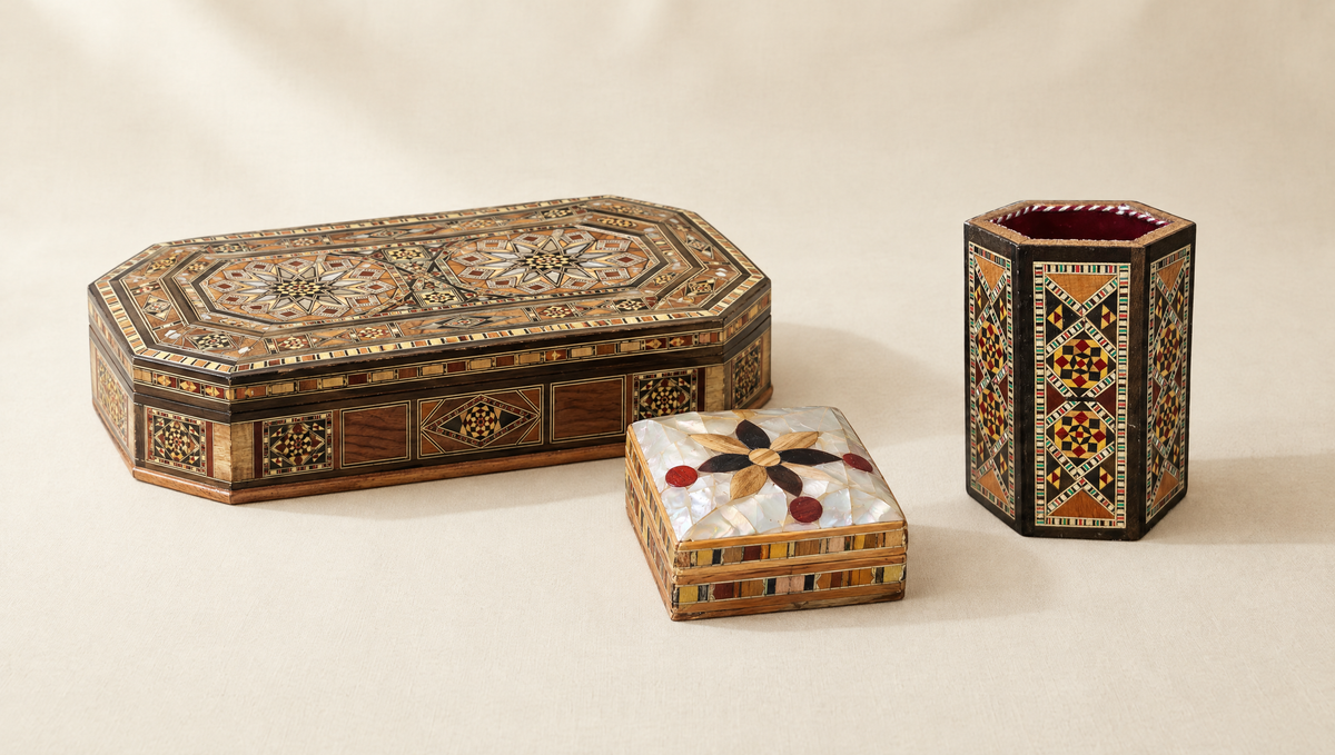 Octagonal Damascene mosaic box, a mother-of-pearl box with an inlaid flower and a hexagonal mosaic pen holder, on cream linen