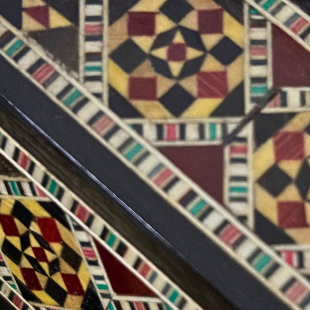 Close-up of the black and wood mosaic on the Poet's Pen Holder