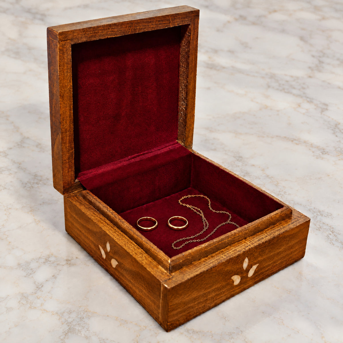 Sultan's Mashghal Box open on marble, wine-red velvet lining with two rings and a chain