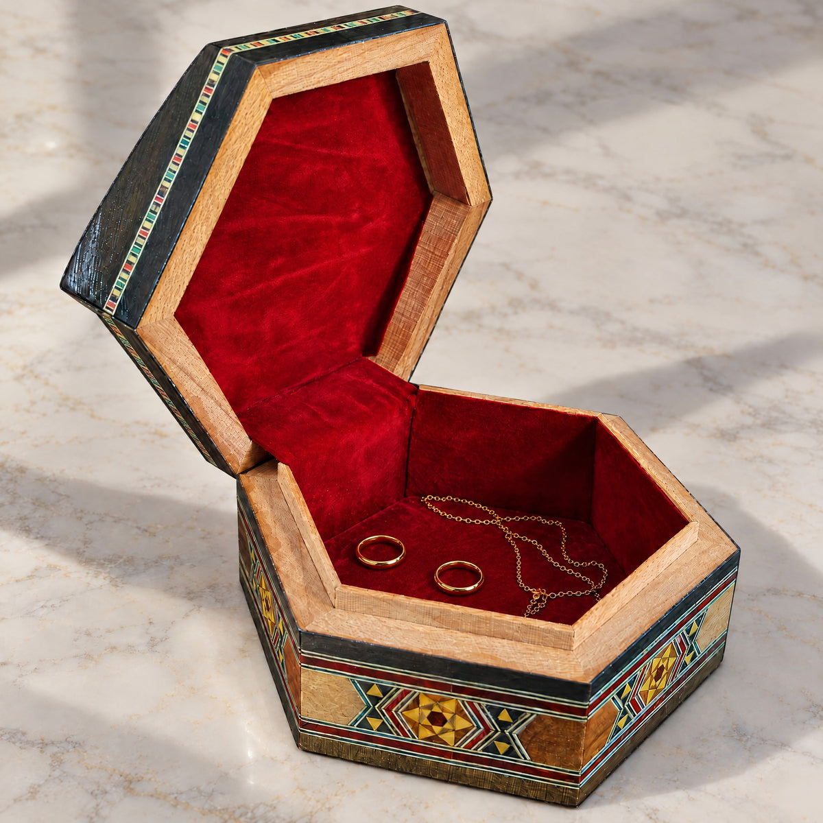 Pearl Mosaic Box open on marble, velvet-lined interior with two rings and a chain