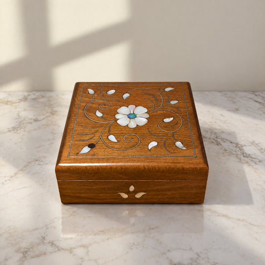 Noble Carved Box on a white marble table in warm window light