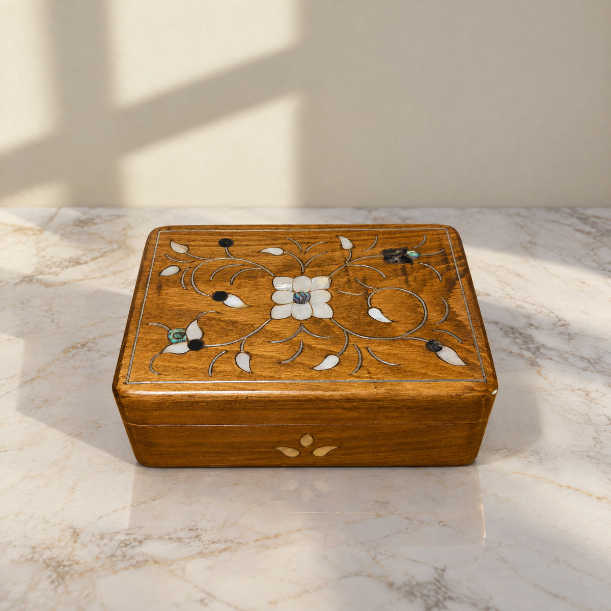 Prestige Carved Box on a white marble table in warm window light