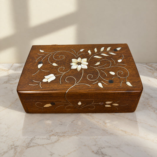 Imperial Carved Box on a white marble table in warm window light