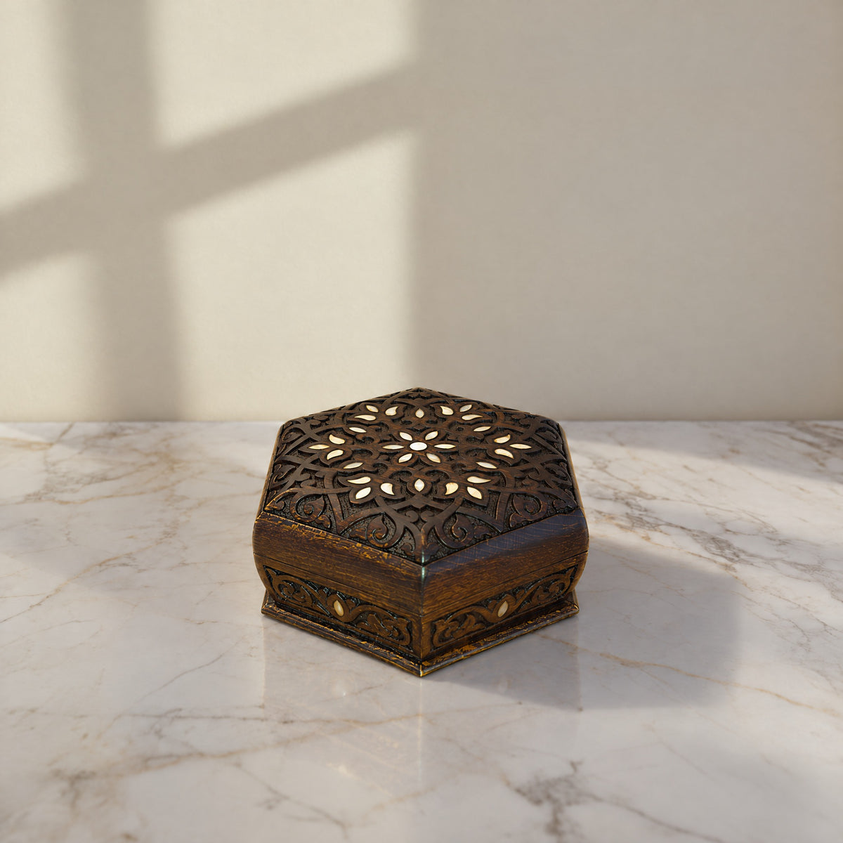 Fine Carved Damascene Box on a white marble table in warm window light