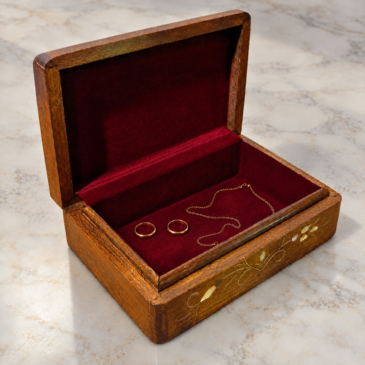 Imperial Mashghal Box open on marble, wine-red velvet lining with two rings and a chain