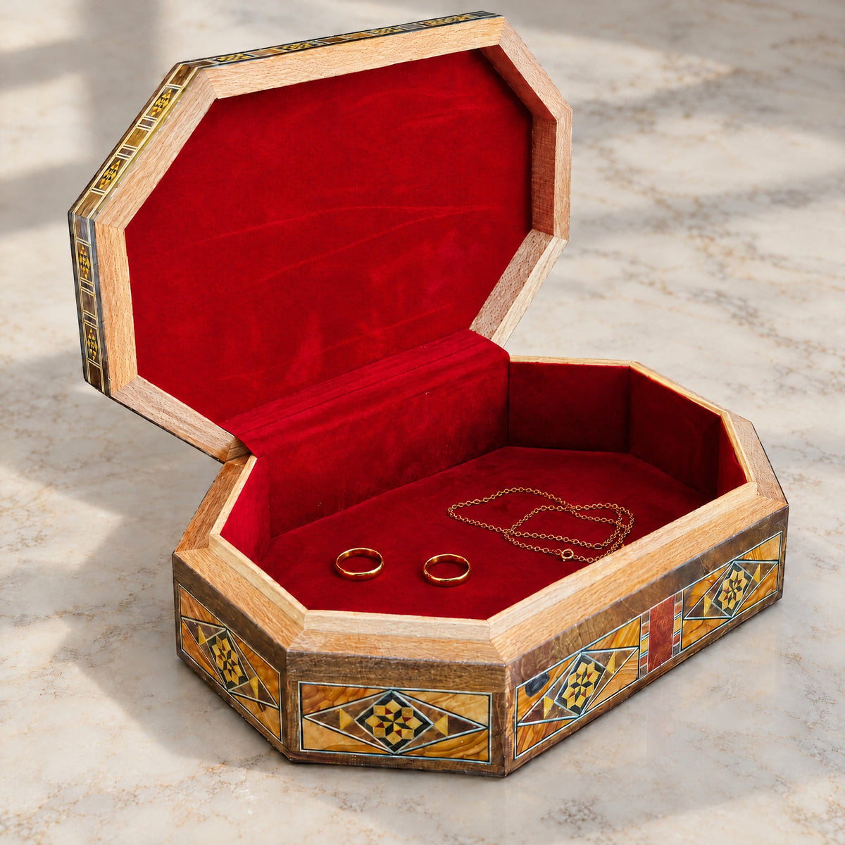 Artisan Mosaic Box open on marble, velvet-lined interior with two rings and a chain