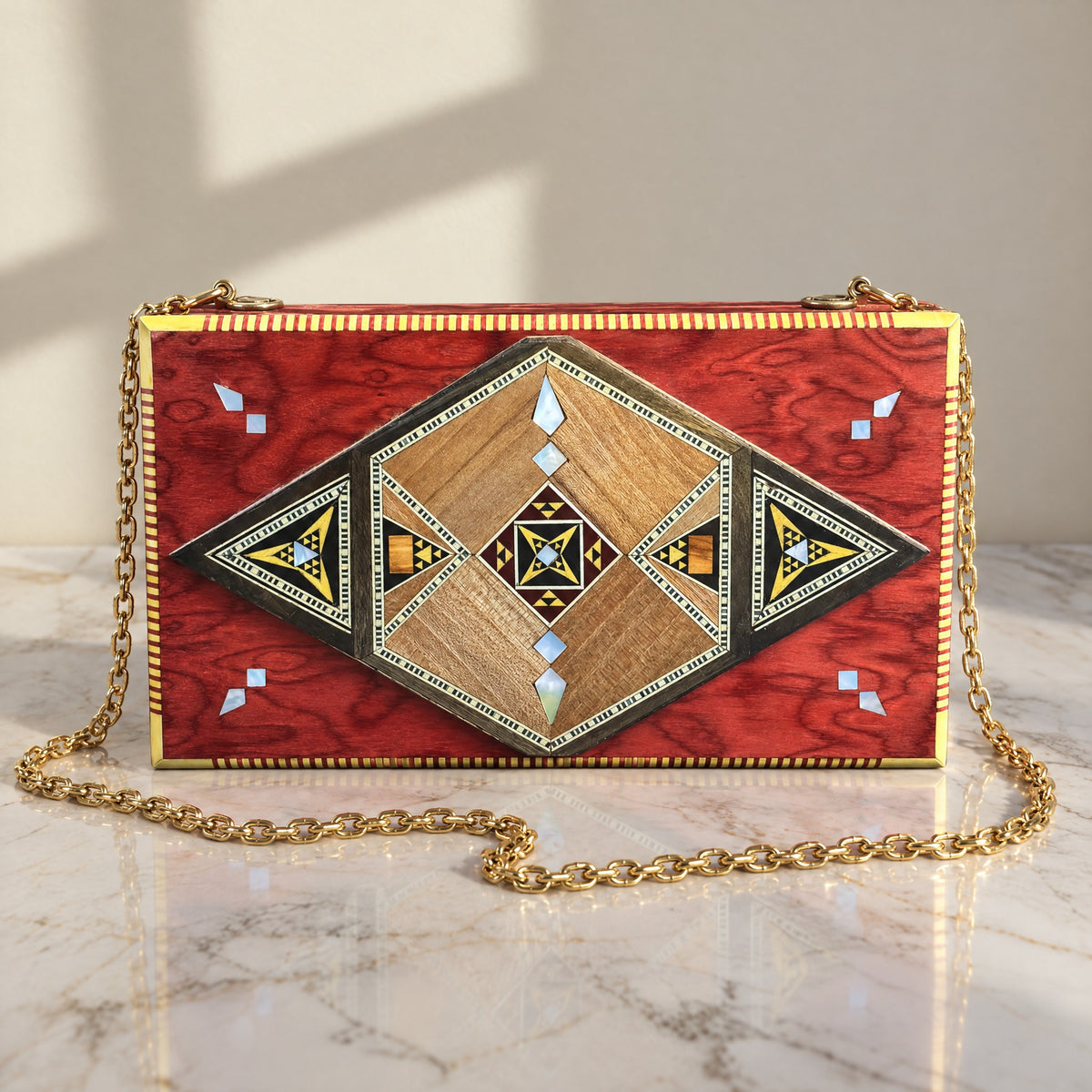 Noor Damascene Clutch on a white marble table in warm window light