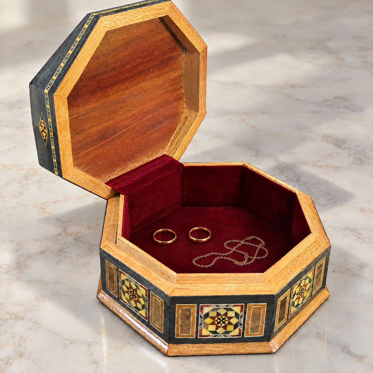 Craftsman Mosaic Box open on marble, velvet-lined interior with two rings and a chain