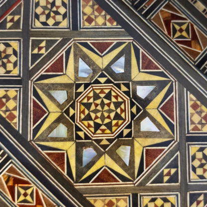 Close-up of the mother-of-pearl inlay pattern on the Qamar Damascene Clutch