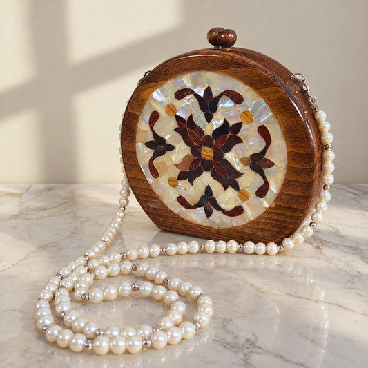 Wardeh Walnut Clutch on a white marble table in warm window light