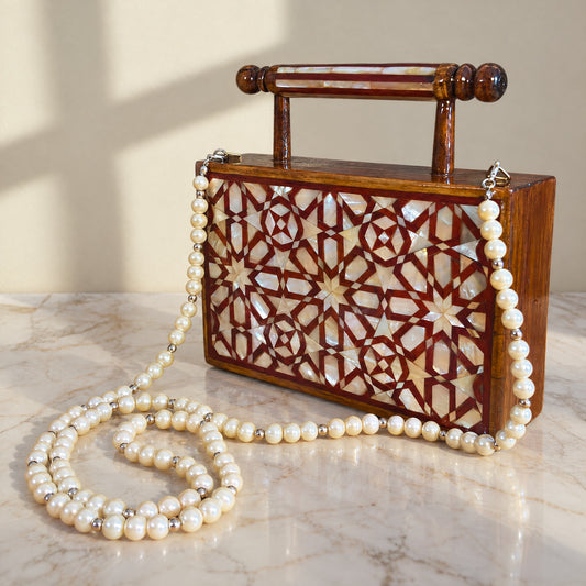 Rose Walnut Clutch on a white marble table in warm window light