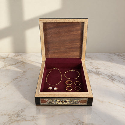Tranquil Mosaic Box open, showing its wine-red velvet lining with a gold necklace, bracelet, rings and pearl earrings