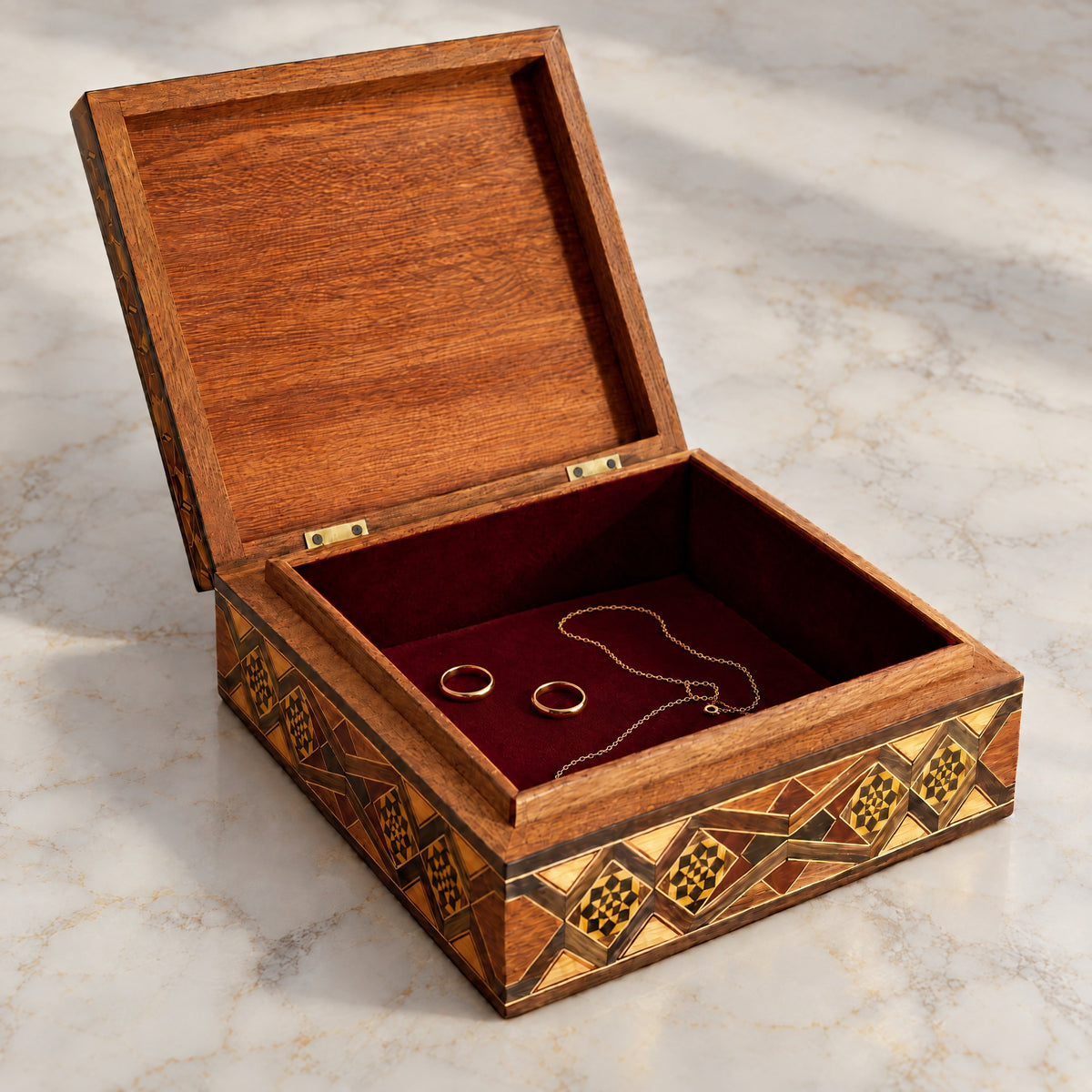 Venerable Mosaic Box open on marble, velvet-lined interior with two rings and a chain