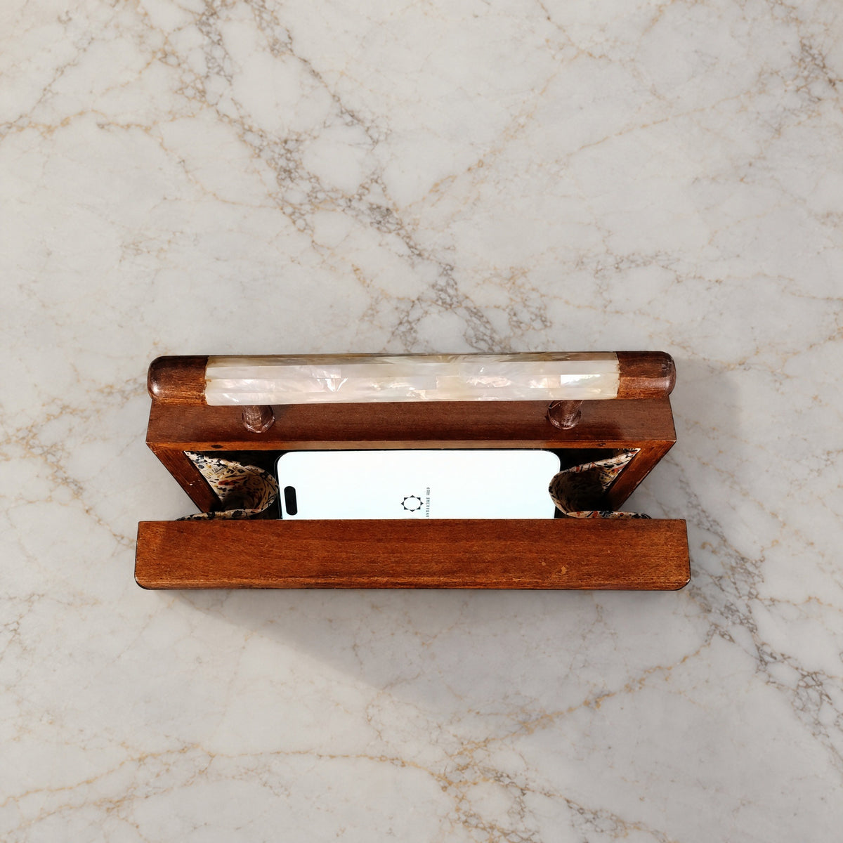 Yasmine Walnut Clutch open on marble with a smartphone inside