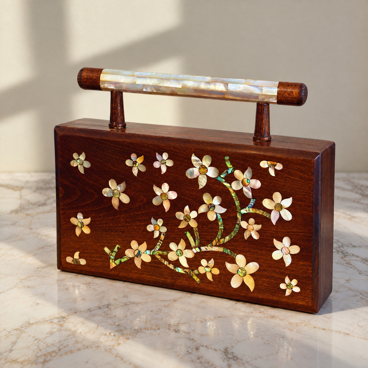 Yasmine Walnut Clutch, closed, on marble