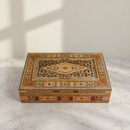Stately Mosaic Box, closed, on a white marble table in warm window light