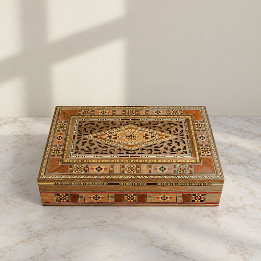 Stately Mosaic Box, closed, on a white marble table in warm window light