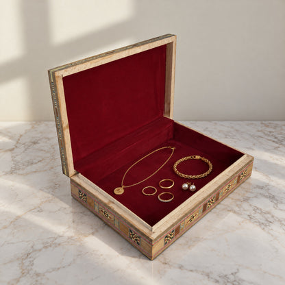 Stately Mosaic Box, open, showing its wine-red velvet lining with a gold necklace, bracelet, rings and pearl earrings