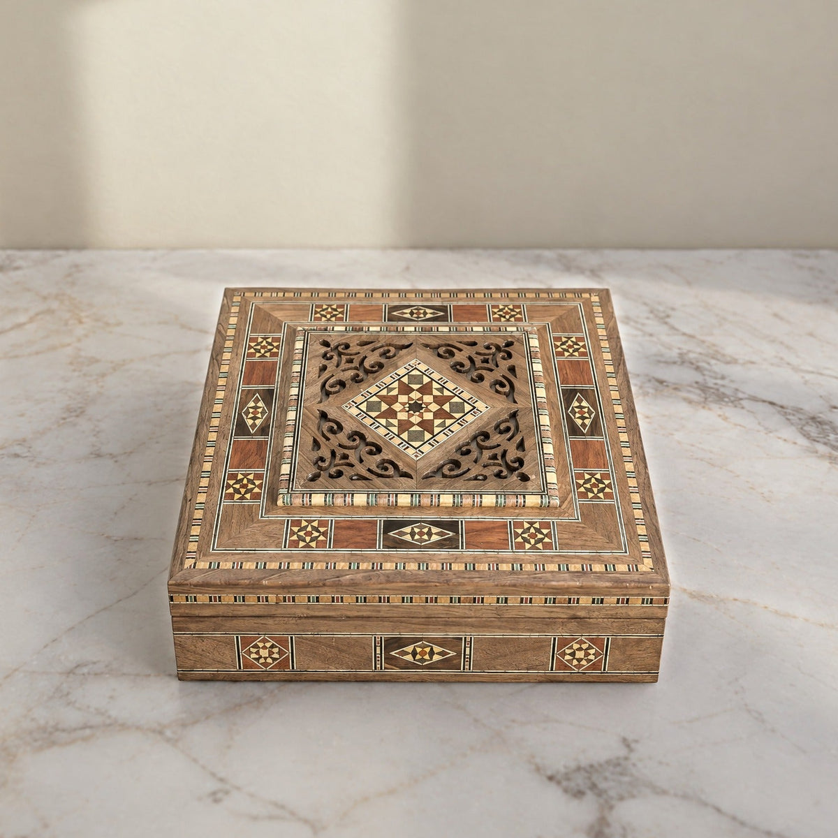 Lantern Mosaic Box, closed, on a white marble table in warm window light