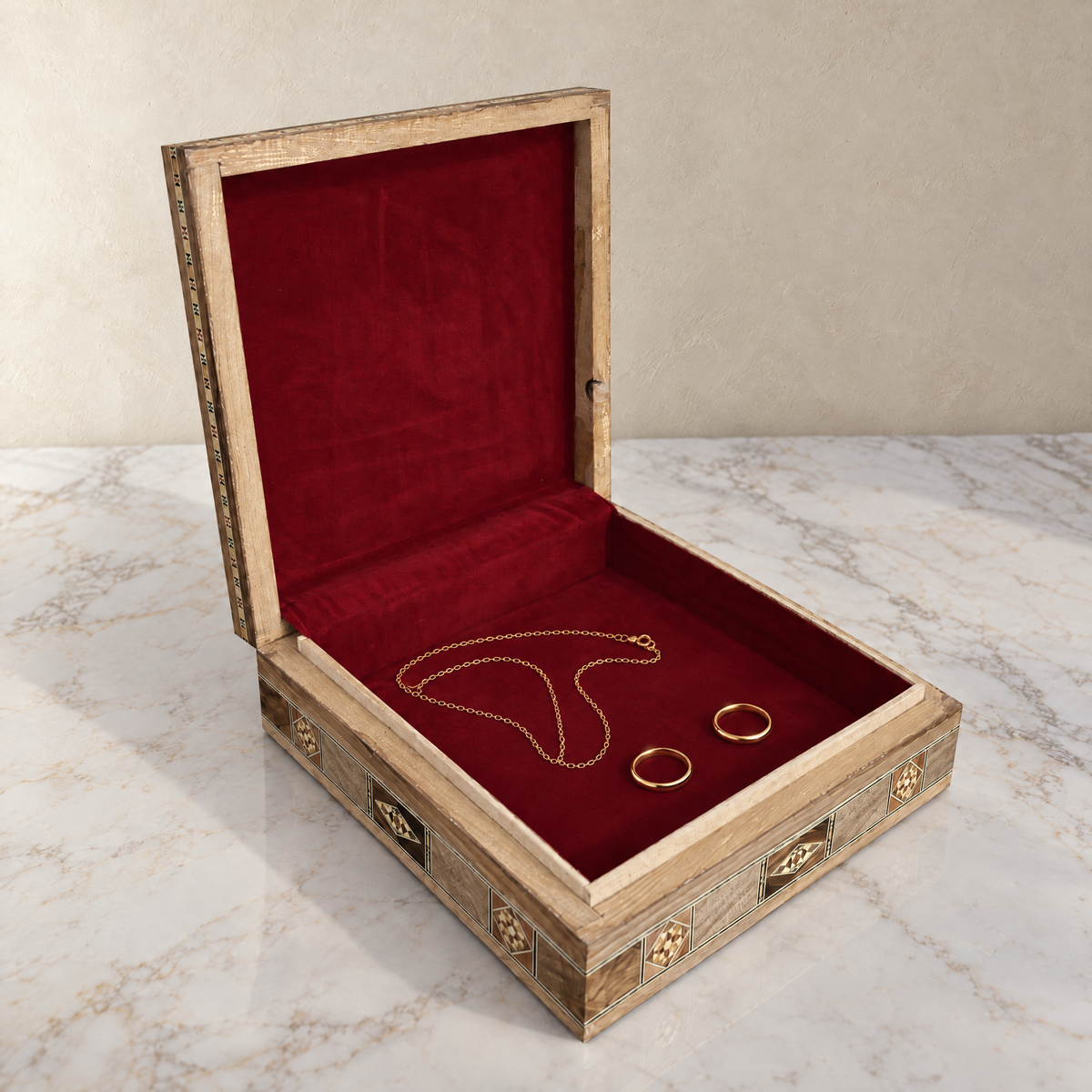 Lantern Mosaic Box open on marble, wine-red velvet lining with two rings and a chain