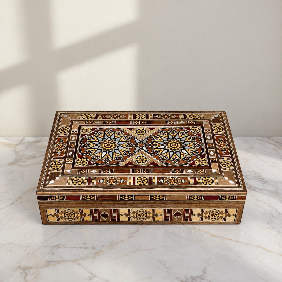 Majestic Mosaic Box, closed, on a white marble table in warm window light