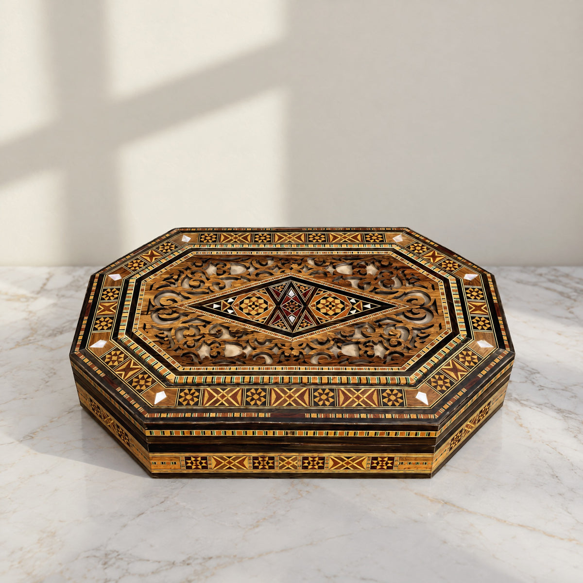 Sovereign Mosaic Box, closed, on a white marble table in warm window light