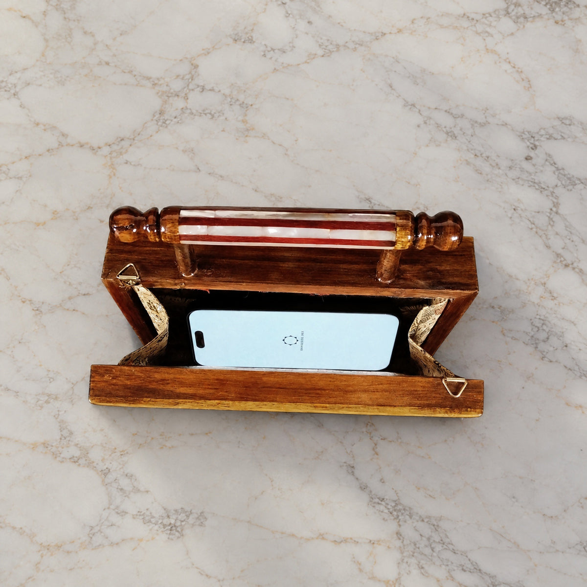Rose Walnut Clutch open on marble with a smartphone inside