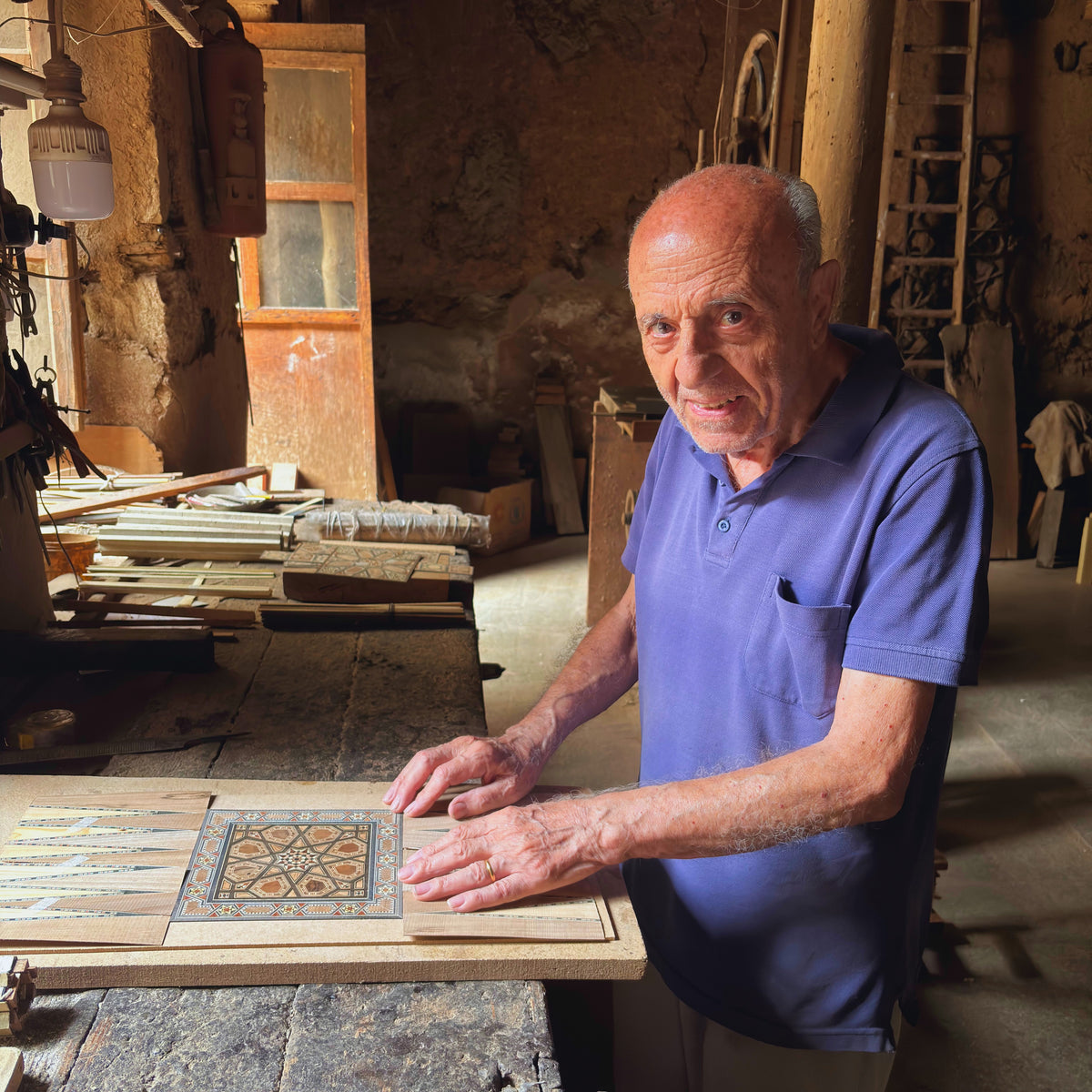 Gabriel Al-Dayeh laying a mosaic panel in his workshop in Damascus