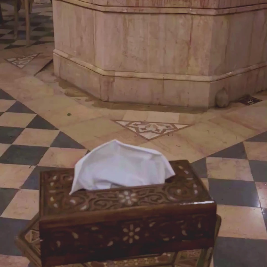 Rosewater Carved Tissue Box video: the tissue box in a courtyard as a tissue is taken