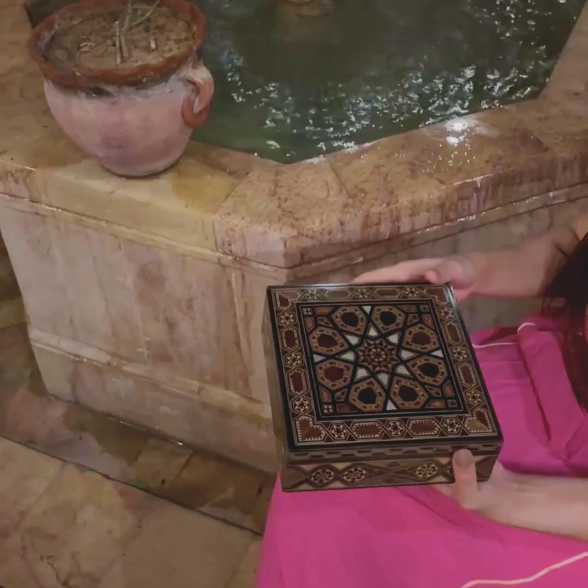 Venerable Mosaic Box video: the box held in a courtyard and opened