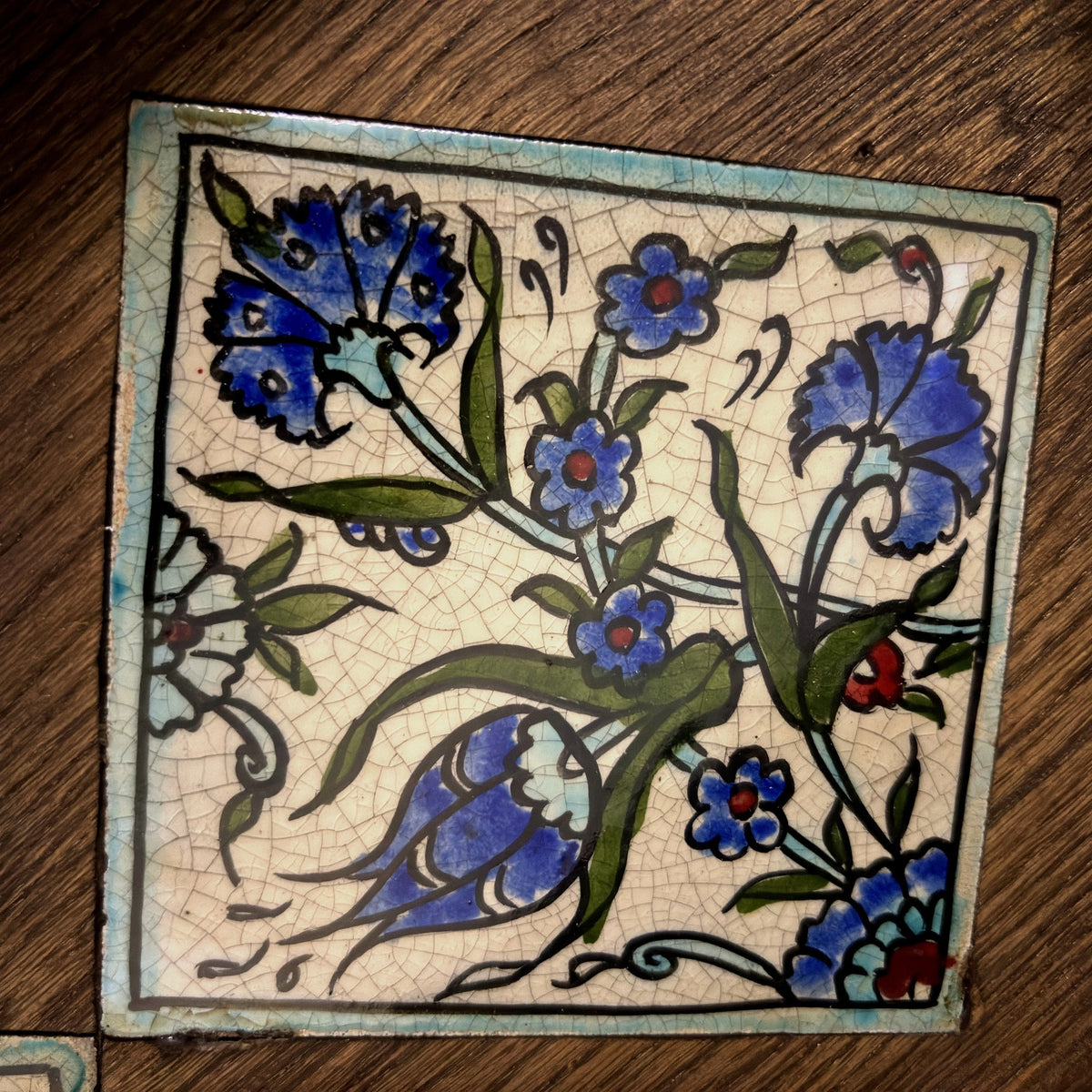 Close-up of a hand-painted glazed ceramic qishani tile on the Jasmine tray